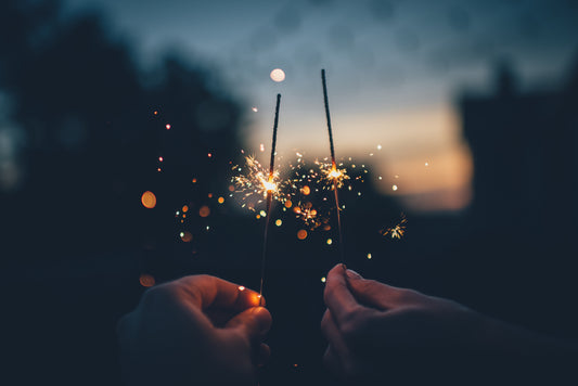 Two sparklers against a dark sky